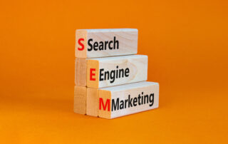 SEM search engine marketing symbol. Wooden blocks with words 'SEM search engine marketing' on beautiful orange background, copy space.